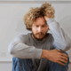 An image of a gay distressed gay man, depicting how HIV diagnosis can affect one's emotional and mental state.