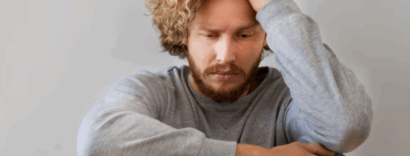 An image of a gay distressed gay man, depicting how HIV diagnosis can affect one's emotional and mental state.