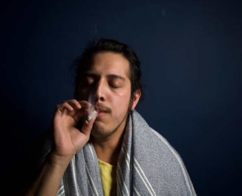 A gay person smoking weed.