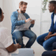A group therapy among LGBTQ persons and a male therapist.