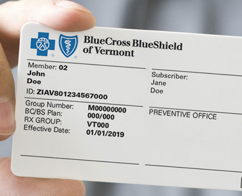 An image of a hand holding Blue Cross Blue Shield insurance card.