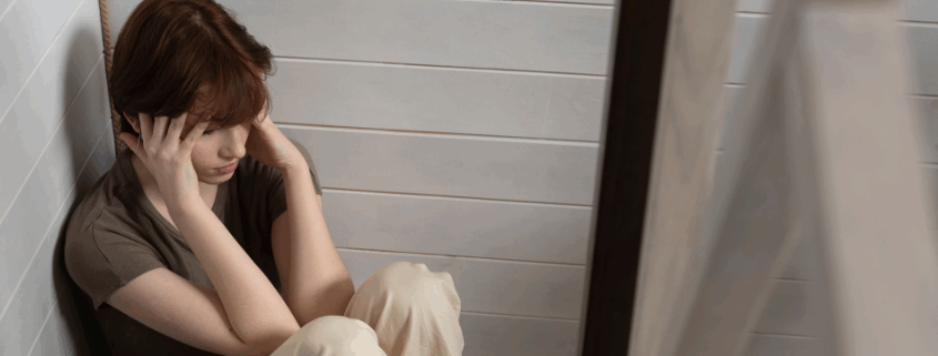 A young lesbian having a panic attacks while on the floor.