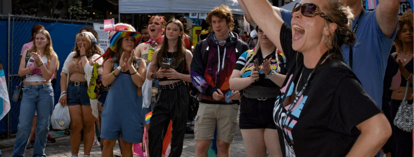 An image of LGBTQ individuals attending pride on the block.
