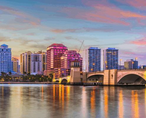 An image buildings and bridge in palm beach gardens across the water.