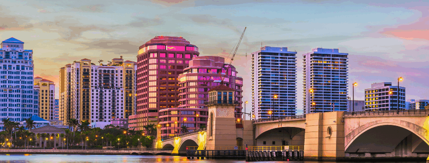 An image buildings and bridge in palm beach gardens across the water.