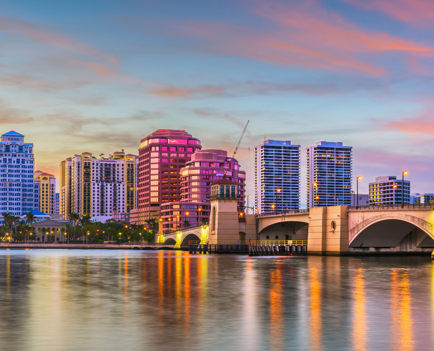 An image buildings and bridge in palm beach gardens across the water.
