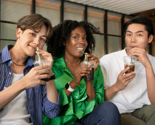A group of LGBTQ individuals enjoying their sips of soda in a sober living home.