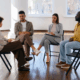 A group of LGBTQ individuals in a sober support group therapy.