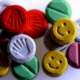 MDA and MDMA tablets of different colors, representing the effects of the drug on someone's mood and emotion