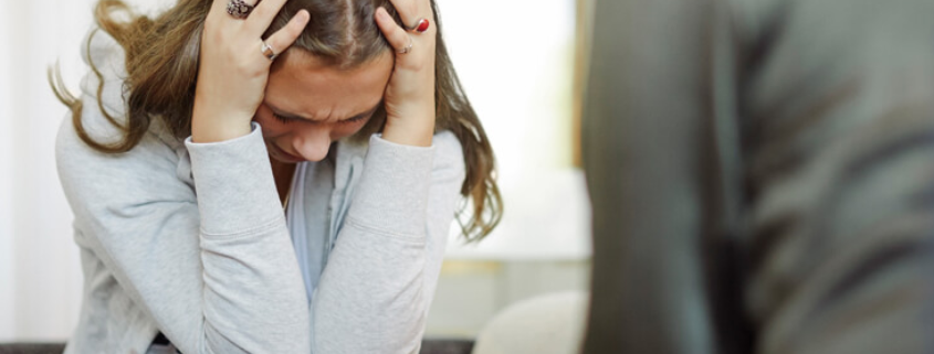 An LGBTQ identified lady struggling from a past trauma during a counselling session in a detox facility