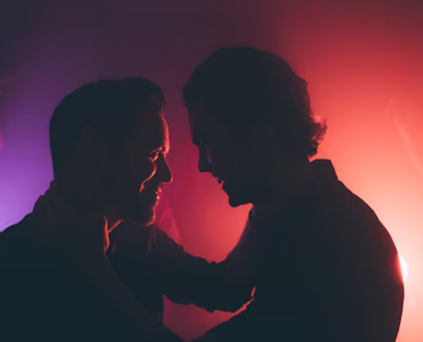 Two gay men happily enjoying nightlife. An image portraying how gay nightlife affects mental health.