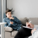 An image of a gay person and a therapist writing on a chart during therapy.